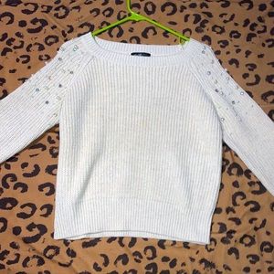 Pearled cream sweater.